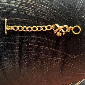 Juicy Couture Bow Starter Bracelet with Dangling Heart Charm.